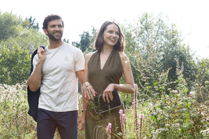 man white female walking in a meadow wearing clothing with pure gold